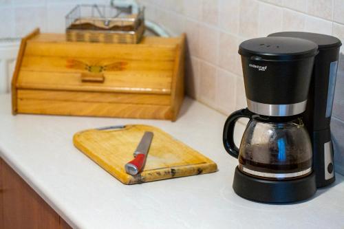 a coffee maker sitting on a kitchen counter with a knife at Kastro Apartments in Panormos Rethymno