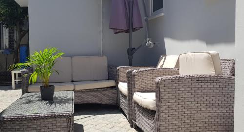2 sillas de mimbre y un sofá en el patio en Studio Anastasia en Limassol