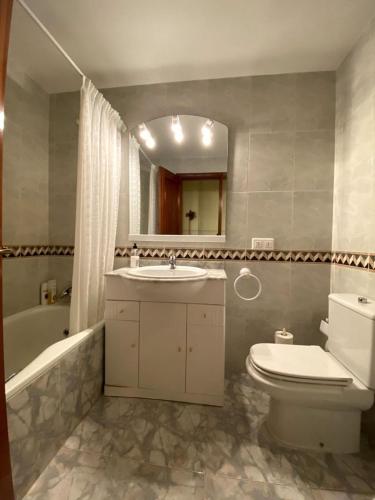 a bathroom with a sink and a toilet and a mirror at Casa La Roya in Castelserás