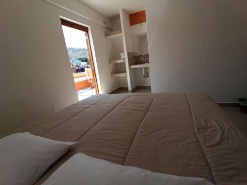 Postel nebo postele na pokoji v ubytování Oaxaquita la Bella