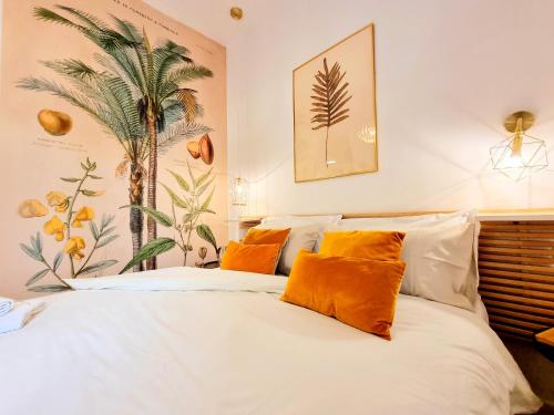 a bedroom with a white bed with orange pillows at Napoli Tree - Lungomare in Naples