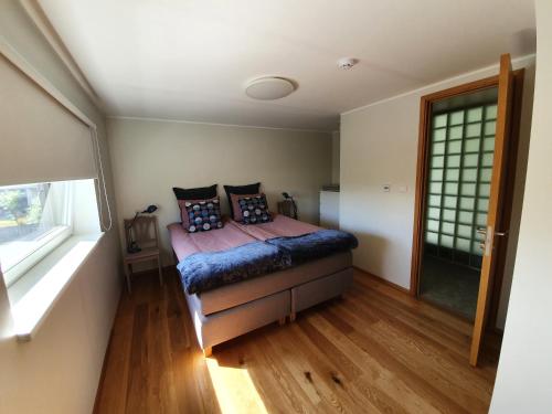 a bedroom with a bed with pillows on it at Elly House in Haapsalu