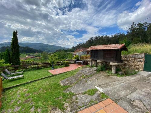 a backyard with a bench and a house at Casa Lagar de Arume in Ponteareas