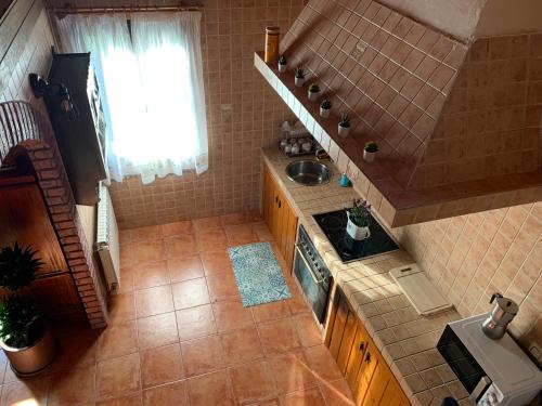 a small kitchen with a sink and a stove at Casa Lagar de Arume in Ponteareas