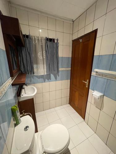 a bathroom with a toilet and a sink at Homestay Studio in Yaoundé