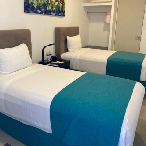 Postel nebo postele na pokoji v ubytování Container Inn Hotel Aeropuerto