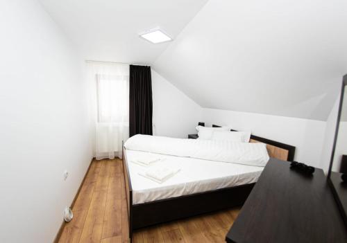 Säng eller sängar i ett rum på Casa Câmpulungeană