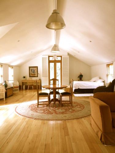 a living room with a table and chairs and a bed at The Loft in Johannesburg