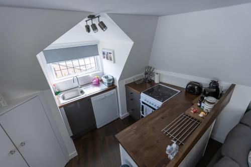 an overhead view of a small kitchen with a table at Beautiful Detached 1 bedroom Apartment in Eltham
