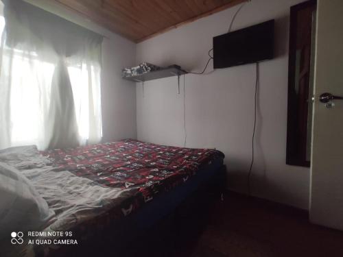 A bed or beds in a room at Hogar COLONIAL