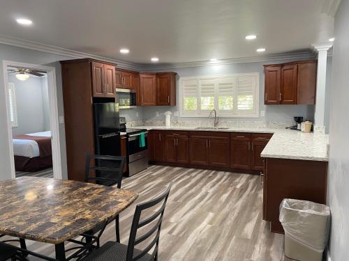 a kitchen with wooden cabinets and a table with chairs at Lone Oak Lodge in Monterey