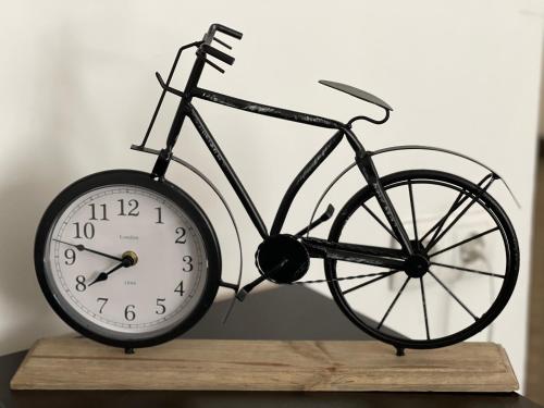 a clock sitting on top of a wooden table at Apartments & Rooms Villa Zaad FREE PRIVATE PARKING in Mostar