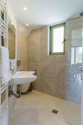 a bathroom with a sink and a shower at Terra Divina Villa in Plakias
