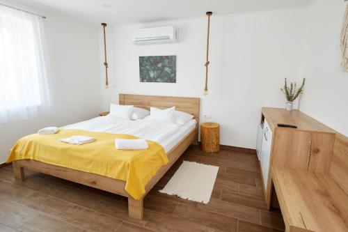 A bed or beds in a room at Naturella Panzió