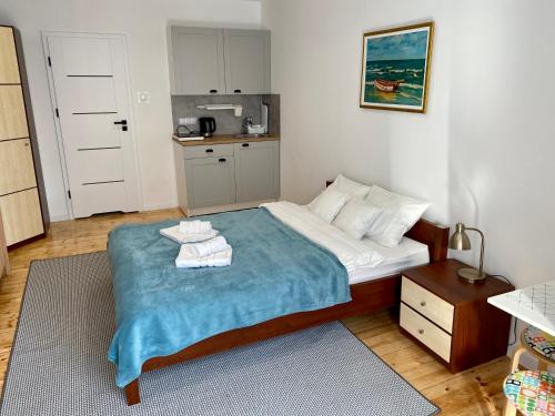 a small bedroom with a bed with towels on it at Apartament na Nadmorskiej in Grzybowo