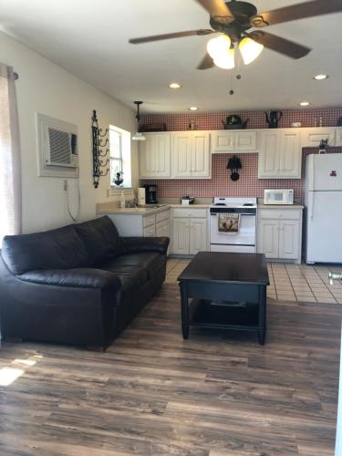 a living room with a black couch and a kitchen at Perfect Country-Side Get-Away in Boerne
