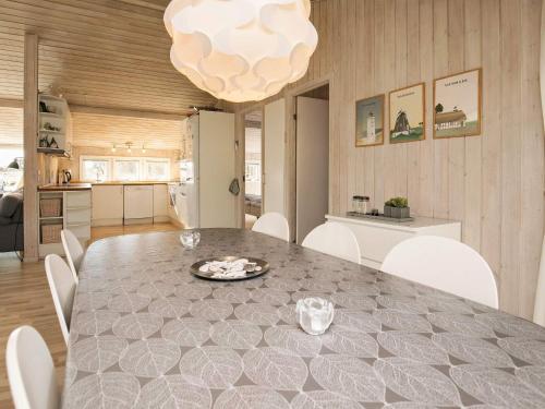 a kitchen and dining room with a table and chairs at 6 person holiday home in Blokhus in Blokhus