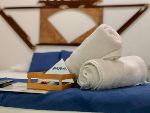 a rolled up towel sitting on top of a bed at Casa Universo Holbox in Holbox Island