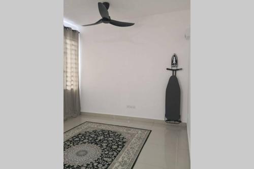 a white room with a ceiling fan and a rug at Homestay Tok Ayah, Behrang Jati in Kampung Behrang