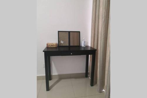 a black desk with a mirror on it in a room at Homestay Tok Ayah, Behrang Jati in Kampung Behrang