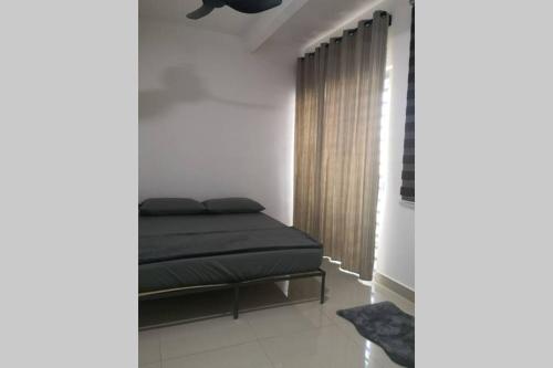 a bedroom with a bed and a window at Homestay Tok Ayah, Behrang Jati in Kampung Behrang