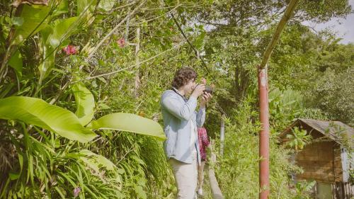 a man taking a picture with a camera at Eco Lodge La Juanita in Manizales