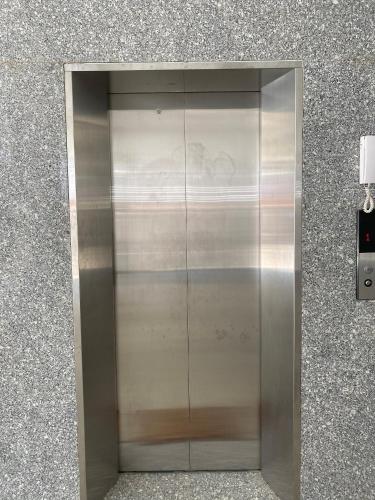 a large metal elevator in a building at Khách sạn Ngọc Bích in Phan Rang