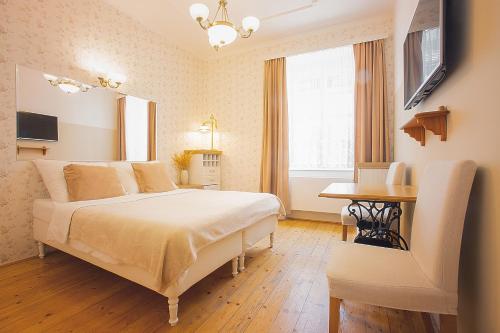 a bedroom with a bed and a desk in it at Wellness Pension Ametyst in Český Krumlov