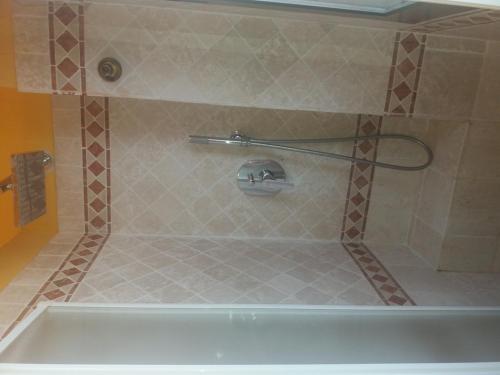 a bath tub in a bathroom with a shower at Villa del Mare Ligure Terme & SPA Piscina a 37 gradi in Santo Stefano al Mare