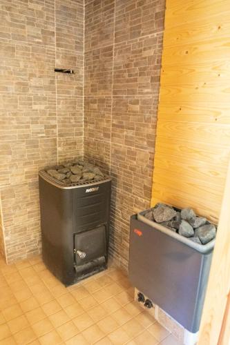 a black stove and a box in a room at Villa Jukola in Teijo