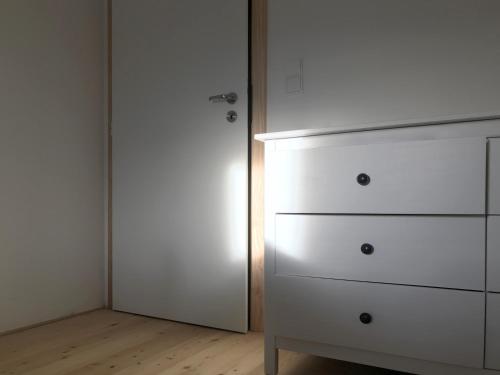 a bedroom with a white dresser and a closet at Penzion Kvilda - Luční in Kvilda