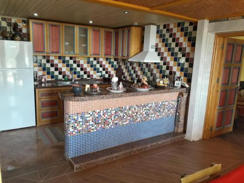 a kitchen with a counter with dishes on it at Villa Symbola in Oludeniz