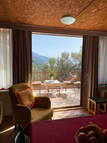 a living room with a view of a patio at Villa Symbola in Oludeniz