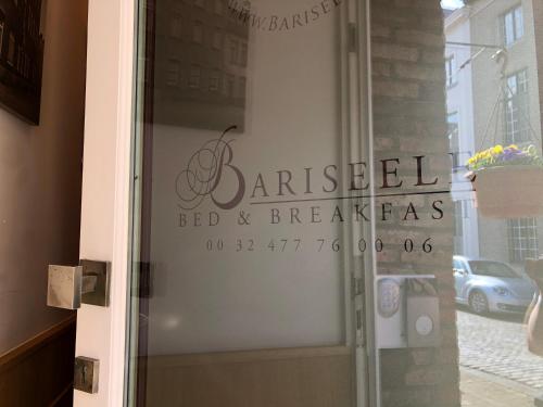 a glass door with a sign that reads garageledledledled bed and breakfast at Bariseele B&B in Bruges