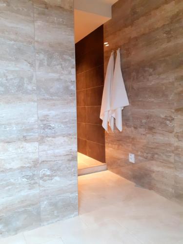 a bathroom with wooden walls and a towel hanging on a wall at Apartmány v centru - Lázně Kynžvart in Lázně Kynžvart