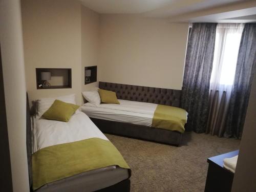Postel nebo postele na pokoji v ubytování Hotel Ponti