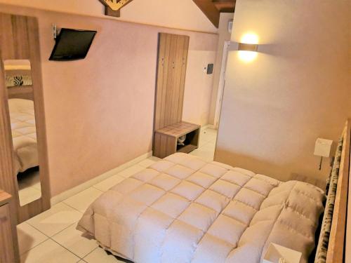 a bedroom with a bed and a television in it at B&B Acireale - Il Cavalluccio Marino Fronte Mare in Acireale