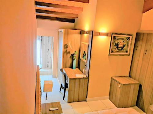 a room with a desk and a table with a mirror at B&B Acireale - Il Cavalluccio Marino Fronte Mare in Acireale