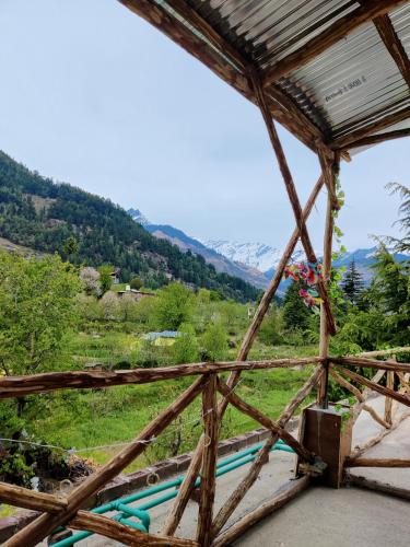 a view from the inside of a wooden structure with a mountain at Safar Hostel Manali in Manāli