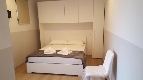 a small bedroom with a bed and a chair at Rocca Palazzaccio in Impruneta