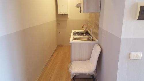 a small kitchen with a sink and a stove at Rocca Palazzaccio in Impruneta