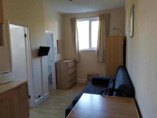 a living room with a couch and a table at Coombe Lodge Holiday Flats in Paignton