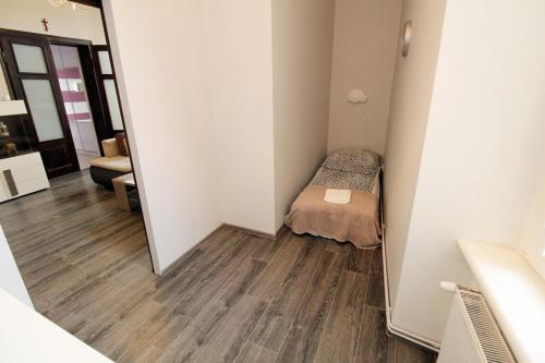 Habitación pequeña con cama y espejo. en Apartament ToTu, en Toruń