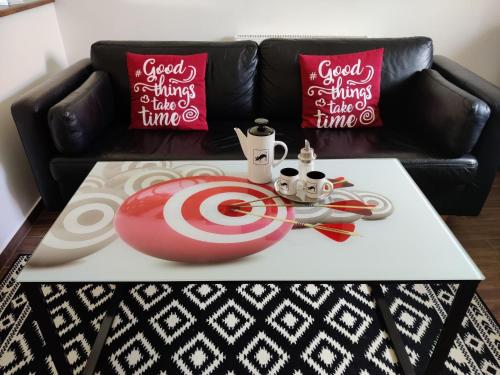 a coffee table with a target on top of a couch at Apartman Biskupice in Fiľakovo