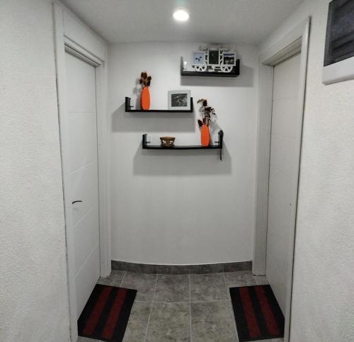 a hallway with orange vases on the wall at Apartmani Zlatarski DAR in Nova Varoš