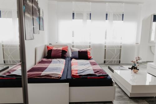 a bedroom with a bed and a table at SK Apartments - Blue in Gelsenkirchen