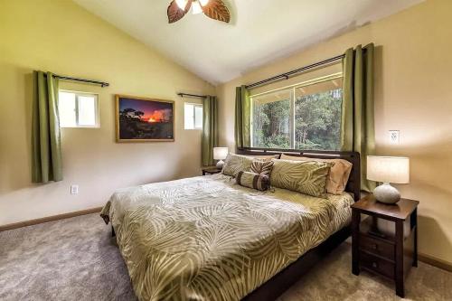 a bedroom with a bed and a window at Tropical Island Paradise home in Volcano