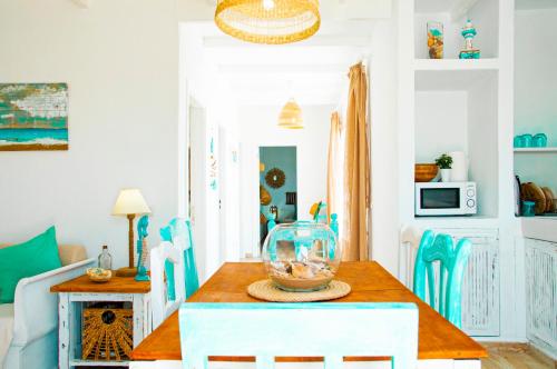 a dining room with a table with a fish bowl on it at Turquesa Beach&Pool Apartaments in Playa Honda