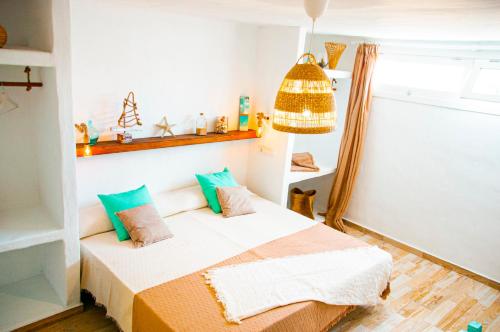 a small room with a bed and a shelf at Turquesa Beach&Pool Apartaments in Playa Honda