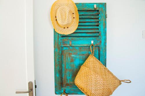 a straw hat and a bag hanging on a door at Turquesa Beach&Pool Apartaments in Playa Honda